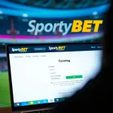 Mobile phone displaying the SportyBet app interface with Nigerian flag colors